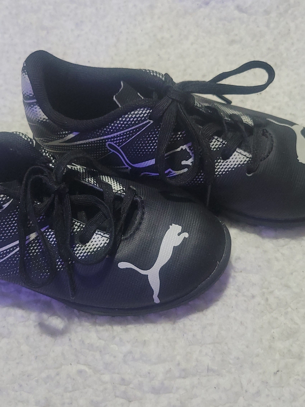 Puma Black Kids Indoor Soccer Shoes with White Puma Logo and Silver Accents